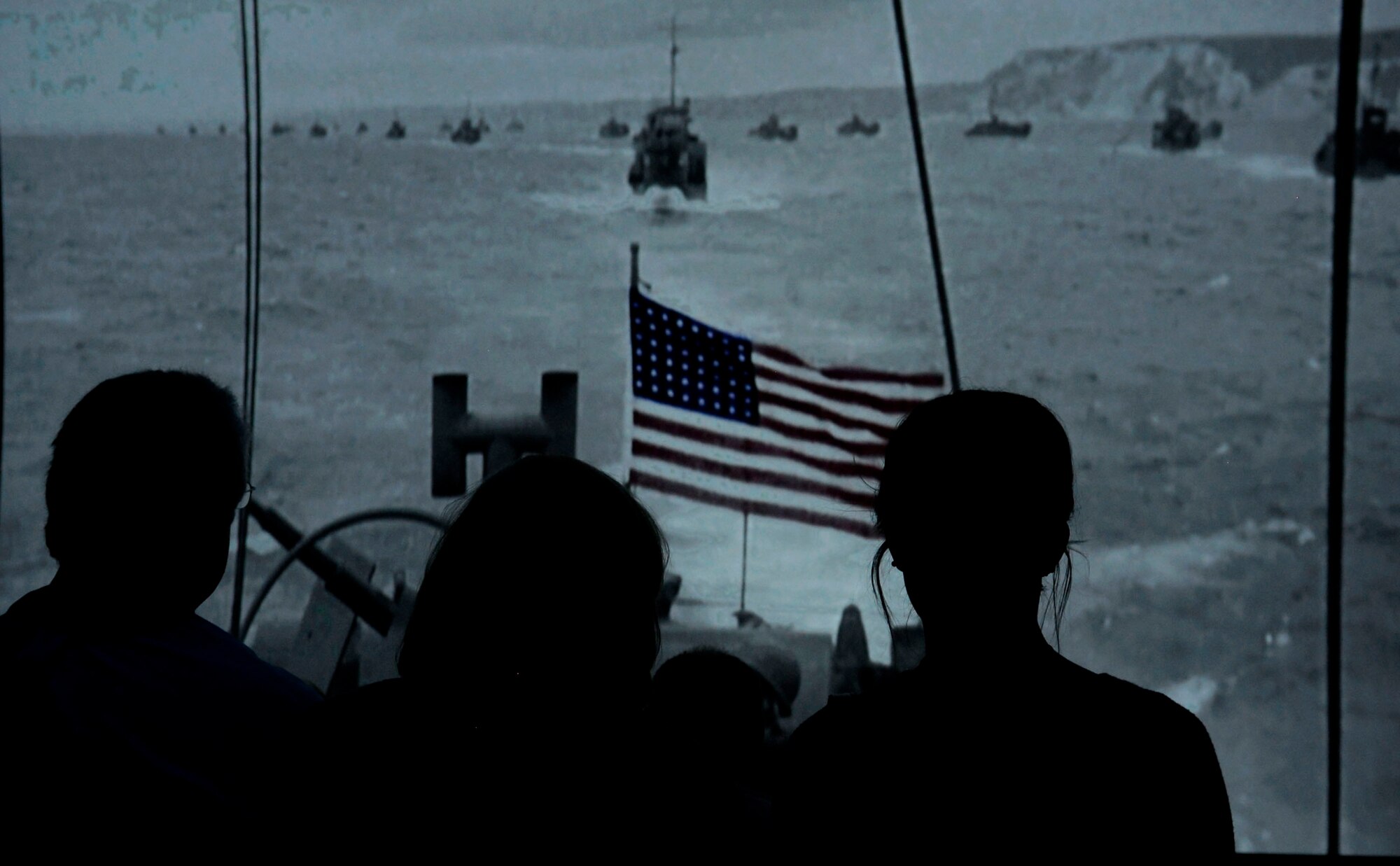 Guests from the 100th Bomb Group Foundation reunion watch a visual presentation at the National World War ll museum Sept. 25, 2015, in New Orleans, La. The 100th Bomb Group Foundation is dedicated to the preservation and dissemination of first-hand historical accounts of the men, missions and machines that fought in the skies over Europe during World War ll. (U.S. Air Force photo by Senior Airman Victoria H. Taylor/Released)