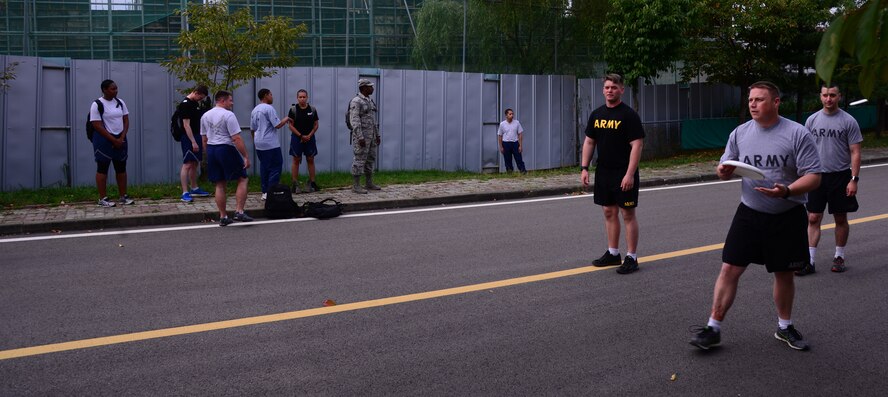 Members of Team Osan practice and warm up before the start of the ultimate frisbee competition Sept. 30, 2015, at Osan Air Base, Republic of Korea. The competition was held Sept. 29-30, and was open to all squadrons, groups, divisions, tenant units and other organizations assigned to Osan. (U.S. Air Force photo by Staff Sgt. Benjamin Sutton) 
