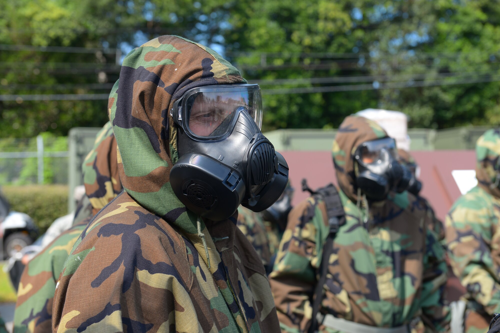 Airmen participate in a Chemical, Biological, Radiological, Nuclear and Explosives defense survival skills refresher course at Yokota Air Base, Japan, Sept. 29, 2015. The course helps Yokota Airmen maintain the skills to don chemical-protective gear quickly and correctly, identify and secure unexploded ordinances and secure important assets against chemical damage. (U.S. Air Force Photo by Airman 1st Class Elizabeth Baker/Released)