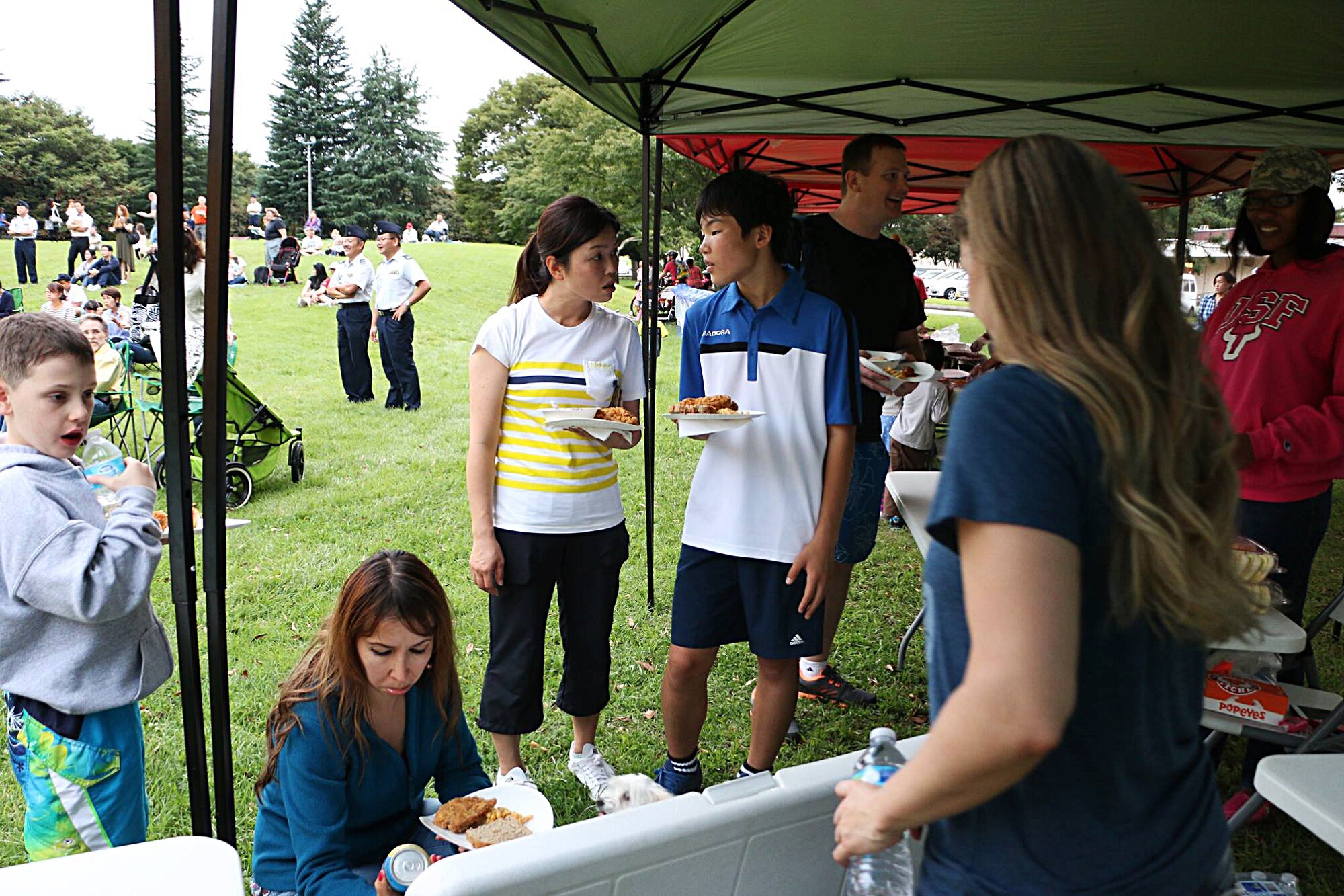 Members of the Yokota community prepare plates of food during the Sexual Assault Awareness Summer Series Concerts Sept. 26, 2015, at Yokota Air Base, Japan. The series concerts were a collection of concerts held throughout the summer to increase awareness regarding sexual assault and promote an assault-free community. (Courtesy photo)