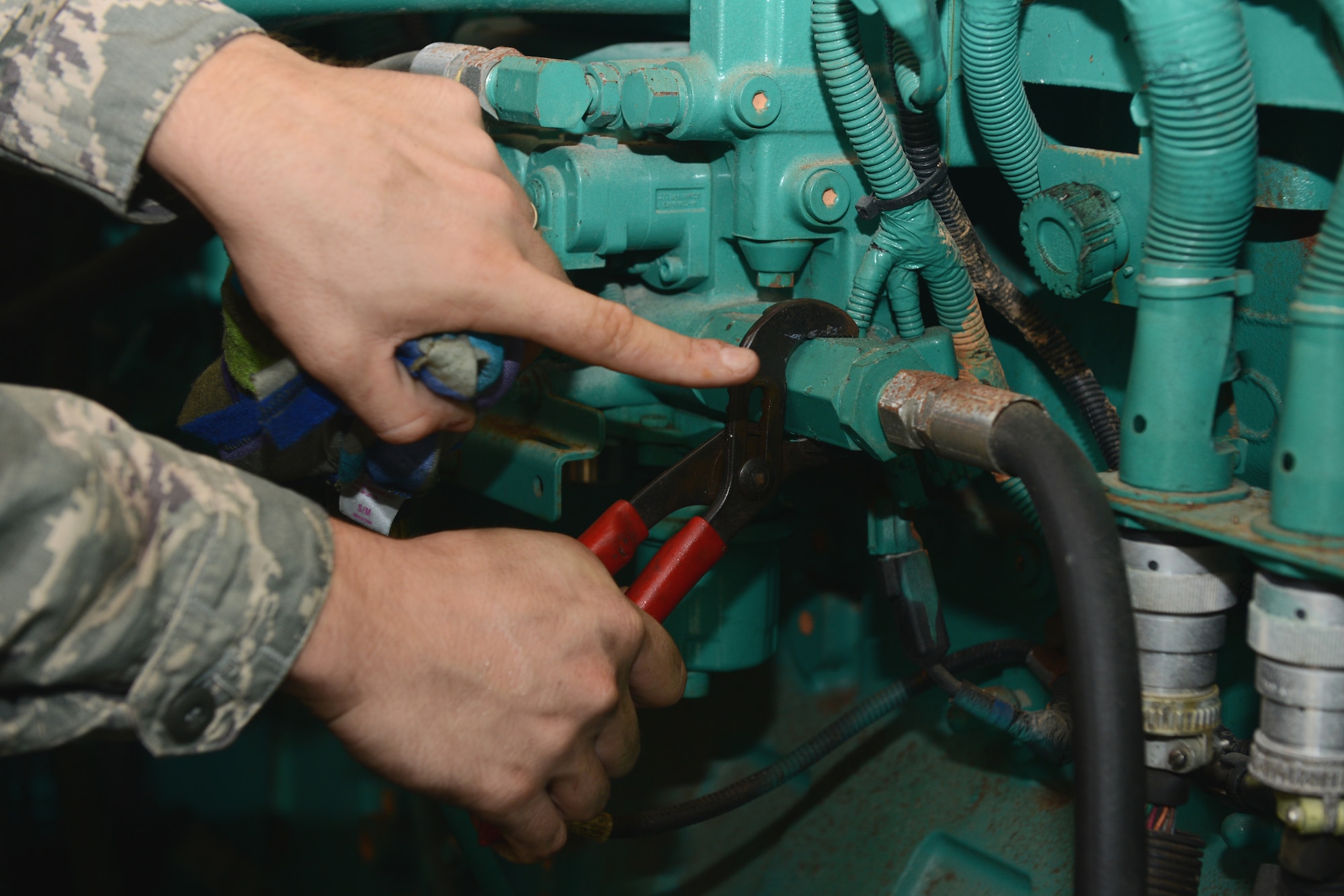 Staff Sgt. Christopher R. Bratton, 36th Civil Engineer Squadron power production craftsman, tightens a fuel strainer on a 350 kilowatt diesel generator Sept. 29, 2015, at Andersen Air Force Base, Guam. Engineers constantly battle corrosive rust that plagues the base infrastructure. (U.S. Air Force photo by Airman 1st Class Arielle Vasquez/Released)