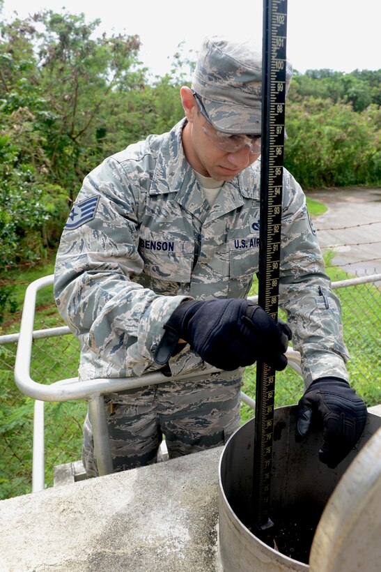 Staff Sgt. Robert A. Benson, 36th Civil Engineer Squadron power production craftsman, checks a 3,000 gallon diesel fuel tank for water Sept. 29, 2015, at Andersen Air Force Base, Guam. The tank is utilized by an emergency generator. (U.S. Air Force photo by Airman 1st Class Arielle Vasquez/Released)