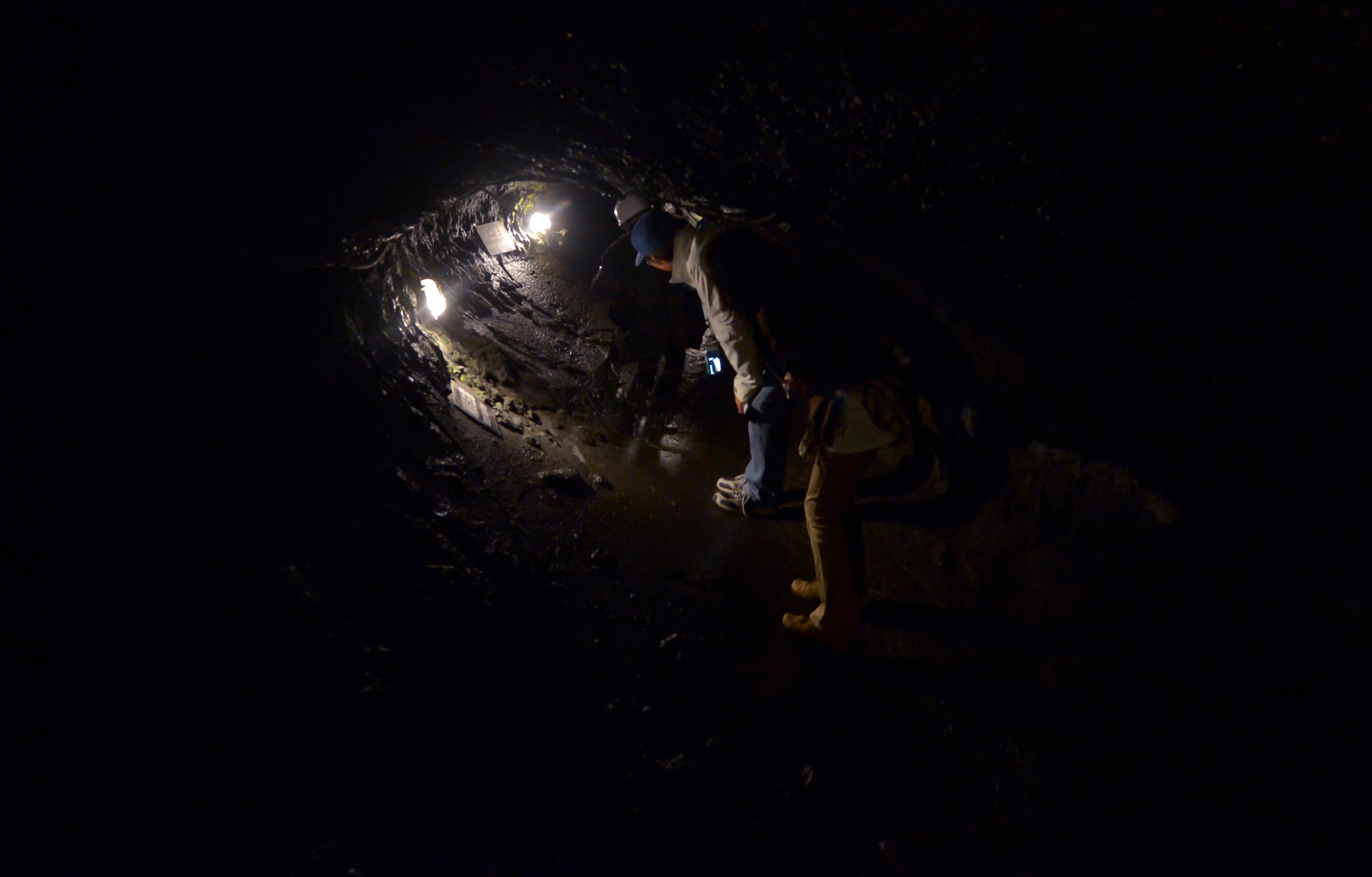 Japanese sightseers duck their heads while moving through the Narusawa Hyouketsu Ice Cave in Yamanashi, Japan, Sept. 5, 2015. The ice cave dates back more than 1,150 years, formed around 864 a.d., when Mt. Fuji erupted and the lava formed the cave. (U.S. Air Force photo by Senior Airman David Owsianka/Released)