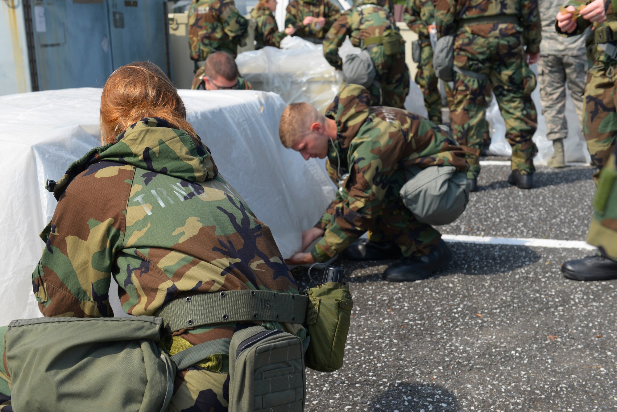 Airmen practice securing an important asset against chemical attack during a Chemical, Biological, Radiological, Nuclear and Explosives defense survival skills refresher course at Yokota Air Base, Japan, Sept. 29, 2015. Yokota personnel train to be prepared to keep mission-critical assets safe in the event of a chemical attack. (U.S. Air Force Photo by Airman 1st Class Elizabeth Baker/Released)