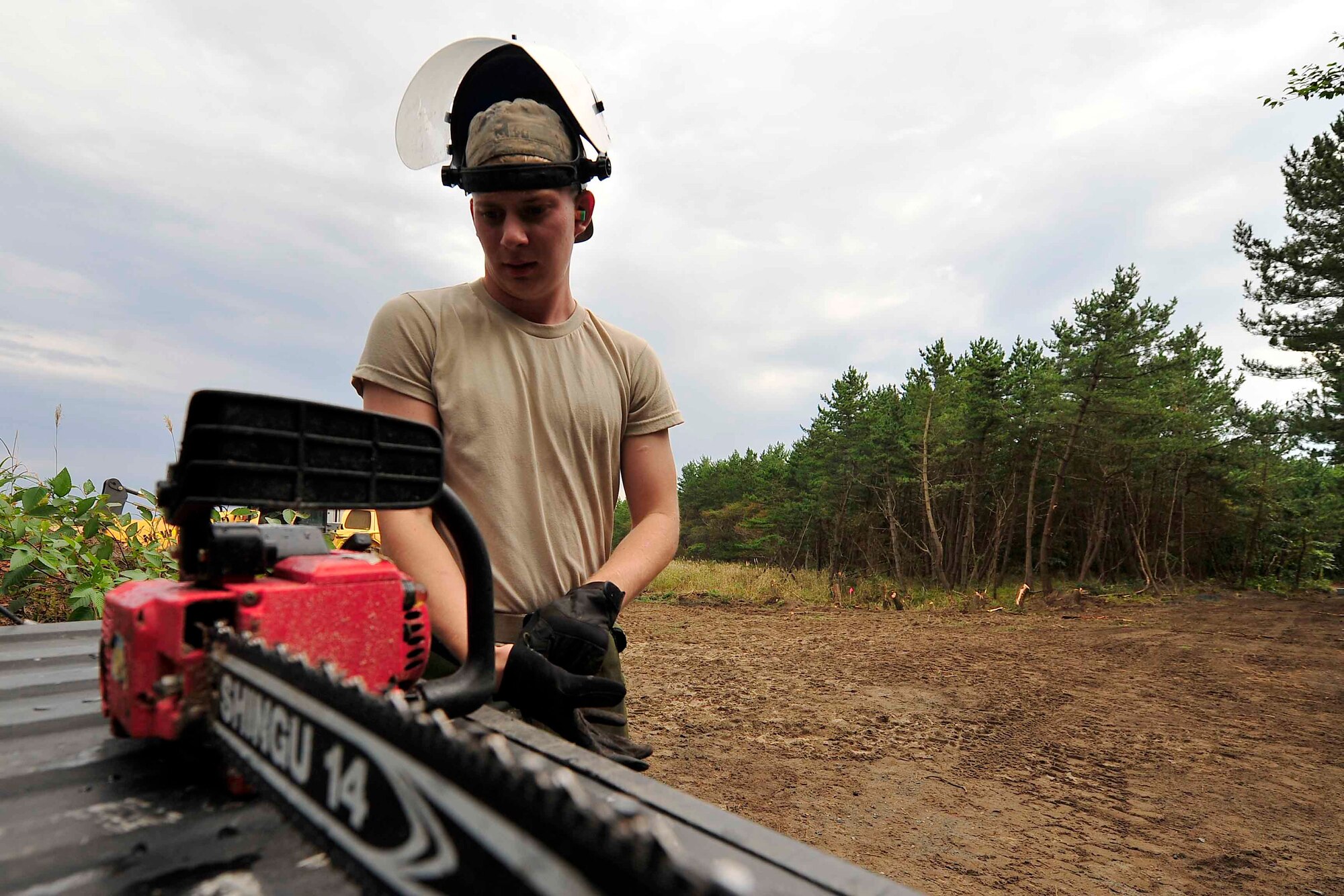 U.S. Air Force Airman Jeffrey Waldron, 35th Civil Engineer Squadron pavement and construction equipment apprentice, prepares to use a chainsaw at Draughon Range, Japan, Sept. 29, 2015. The pavement and construction equipment Airmen, better known as the ?Dirt Boys,? worked and will work on approximately 81,000 square feet of land. (U.S. Air Force Tech. Sgt. April Quintanilla/Released)