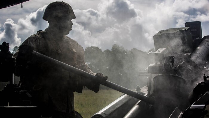 Cpl. Anthony Payton, a field artillery cannoneer with Lima Battery, 2nd Battalion, 10th Marine Regiment, swabs an M777 Howitzer after it was fired during a live-fire exercise at Marine Corps Base Camp Lejeune, North Carolina, Sept. 30, 2015. This was the last exercise Lima conducted as a standalone battery. 