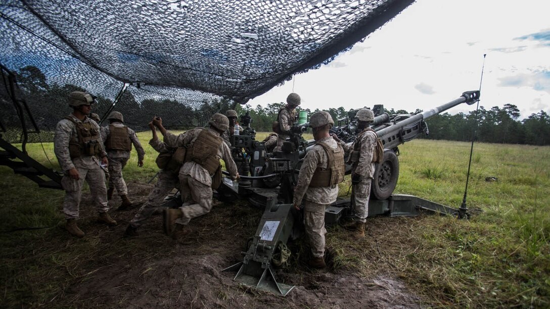 Cpl. Jesse Kincaid (left) and Lance Cpl. Brandon Such (right), field artillery cannoneers with Lima Battery, 2nd Battalion, 10th Marine Regiment, use a ramming rod to help fire an M777 Howitzer during a live-fire exercise at Marine Corps Base Camp Lejeune, North Carolina, Sept. 30, 2015. This was the last exercise Lima conducted as a standalone battery. 