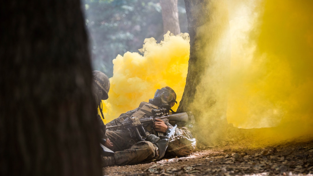 Republic of Korea Marine Lance Cpl. Jun Shin, left, provides buddy aid to a U.S. Marine during a gas attack drill as part of Korean Marine Exchange Program 15-12 at Gunha-Rhi, Republic of Korea, Sept. 17, 2015. The U.S. and ROK Marines practiced quickly putting on their gas mask and carrying the simulated wounded to safety. KMEP 15-12 is an exercise in a series of continuous bilateral training exercises that enhances the ROK and U.S. alliance, promotes stability on the Korean Peninsula and strengthens ROK and U.S. military capabilities and interoperability.