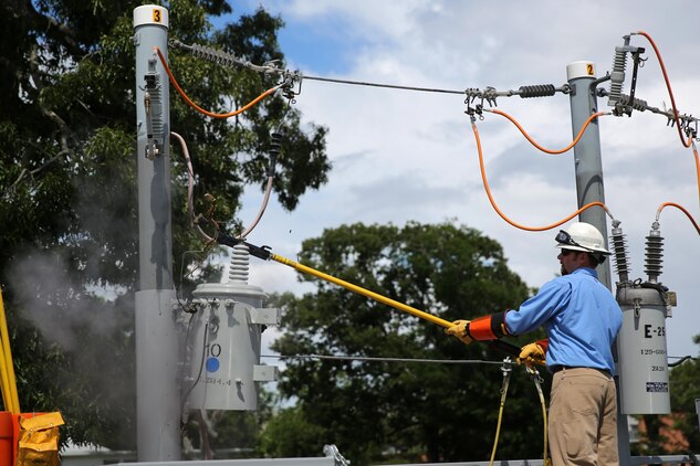 An electrician performs a live-wire safety demonstration during the Emergency Preparedness Fair at the Two Rivers theater at Marine Corps Air Station Cherry Point, N.C., June 4, 2015. During the month of September, the National Preparedness Month grants Marines and their families the opportunity to learn how to prepare and stay safe from natural disasters. Service members and their families were educated at the fair on resources available at Cherry Point and in surrounding communities to prepare for and respond to hurricanes and other natural disasters. (U.S. Marine Corps photo by Cpl. H.W. Huertas/ Released)