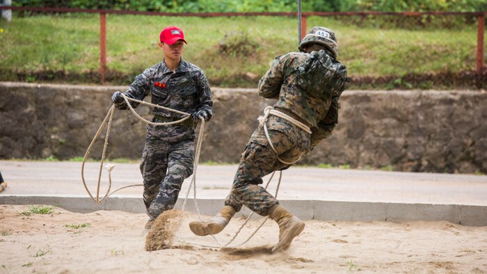U.S. Marine Cpl. Carlson, right, dismounts the rappel rope during a company competition for Korean Marine Exchange Program 15-12 at Yooghuk Dae, Munseu San Mountain, Republic of Korea, Sept. 11, 2015. The U.S. and ROK Marines participated in a race of the fastest company to complete rappelling, rock climbing and rope climbing before a sprint to the finish line. KMEP 15-12 is a bilateral training exercise that enhances the ROK and U.S. alliance, promotes stability on the Korean Peninsula and strengthens ROK and U.S. military capabilities and interoperability. Carlson, from Virginia Beach, Virginia, is a rifleman with Fox Company, 2nd Battalion, 3rd Marine Division and attached through the Unit Deployment Program to III Marine Expeditionary Force. The ROK Marines are with 11th Battalion, 1st Regiment, 2nd Marine Division, ROK Headquarters Marine Corps.