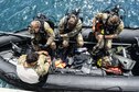 Airmen from the 320th Special Tactics Squadron at Kadena Air Base, Japan, ready their scuba diving gear during an amphibious operations exercise Sept. 22, 2015, off the west coast of Okinawa, Japan. Teamwork is vital to the successful and safe completion of special tactics objectives, especially in the face of adversities such as harsh weather conditions and terrain. (U.S. Air Force photo/Senior Airman John Linzmeier)