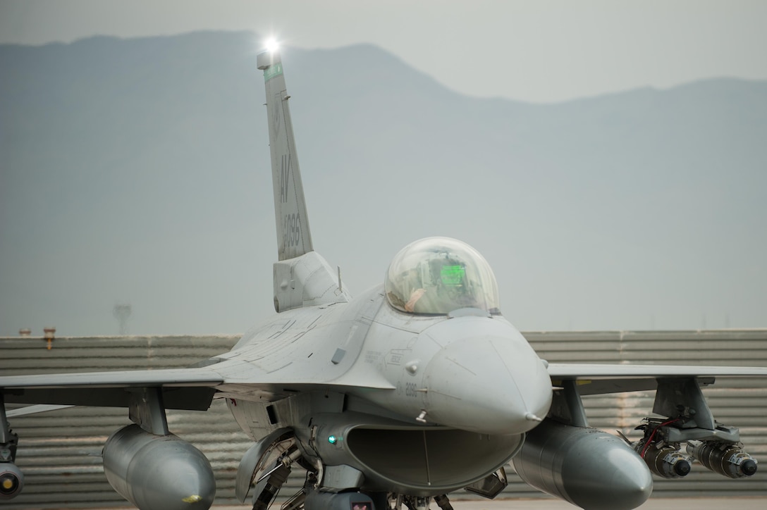 An F-16 Fighting Falcon pilot assigned to the 555th Expeditionary Fighter Squadron goes through a preflight inspection before a combat sortie at Bagram Airfield, Afghanistan, Sept. 22, 2015. The F-16 is a multi-role fighter aircraft that is highly maneuverable and has proven itself in air-to-air and air-to-ground combat. (U.S. Air Force photo/Tech. Sgt. Joseph Swafford)