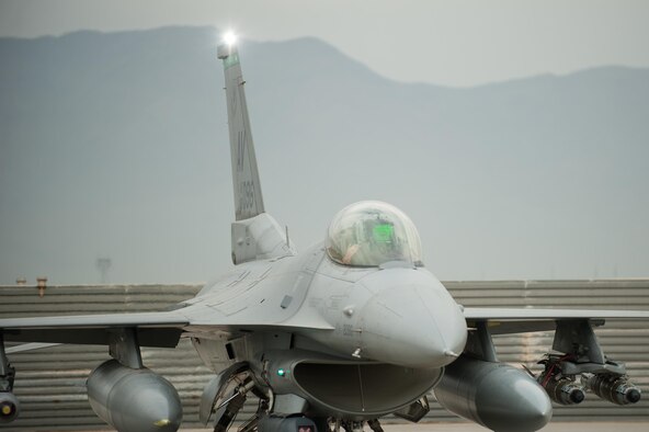 An F-16 Fighting Falcon pilot assigned to the 555th Expeditionary Fighter Squadron goes through a preflight inspection before a combat sortie at Bagram Airfield, Afghanistan, Sept. 22, 2015. The F-16 is a multi-role fighter aircraft that is highly maneuverable and has proven itself in air-to-air and air-to-ground combat. (U.S. Air Force photo/Tech. Sgt. Joseph Swafford)