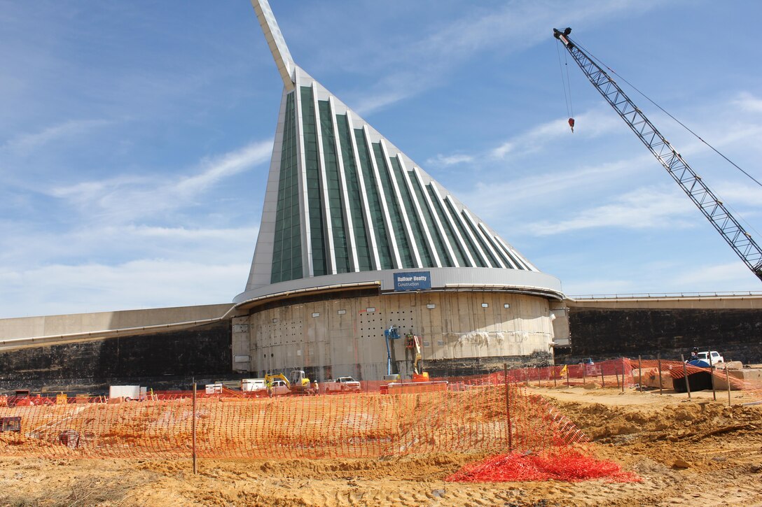 Workers drill holes in the wall of the existing museum. A forklift will fit into the holes to carry away the entire section of wall. This space will be the site of an expanded education suite, a Marine Sports Hall of Fame, a Hall of Valor Gallery, a Marine Corps Combat Art Gallery, and two additional galleries depicting Marine Corps history from 1976 to the present day. 