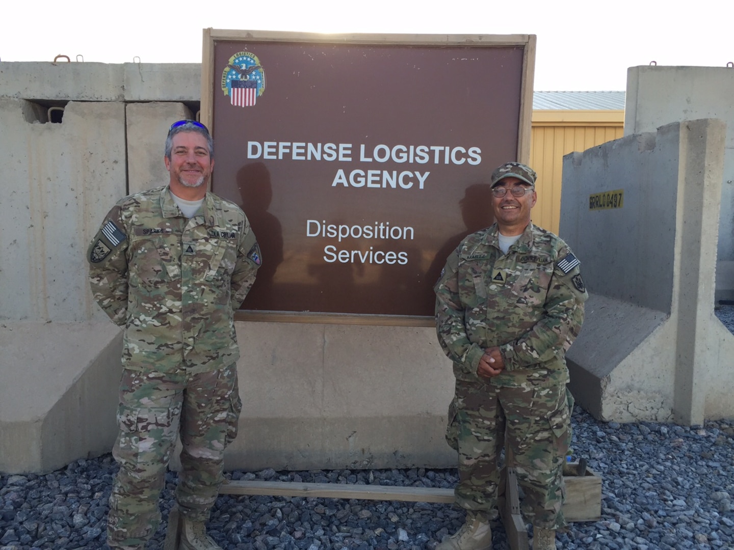 Kent Martz on the right posing with a teammate, a safety specialist at Defense Logistics Agency Distribution Red River, Texas, has spent the last six months in Afghanistan supporting the MRAP Demilitarization mission.