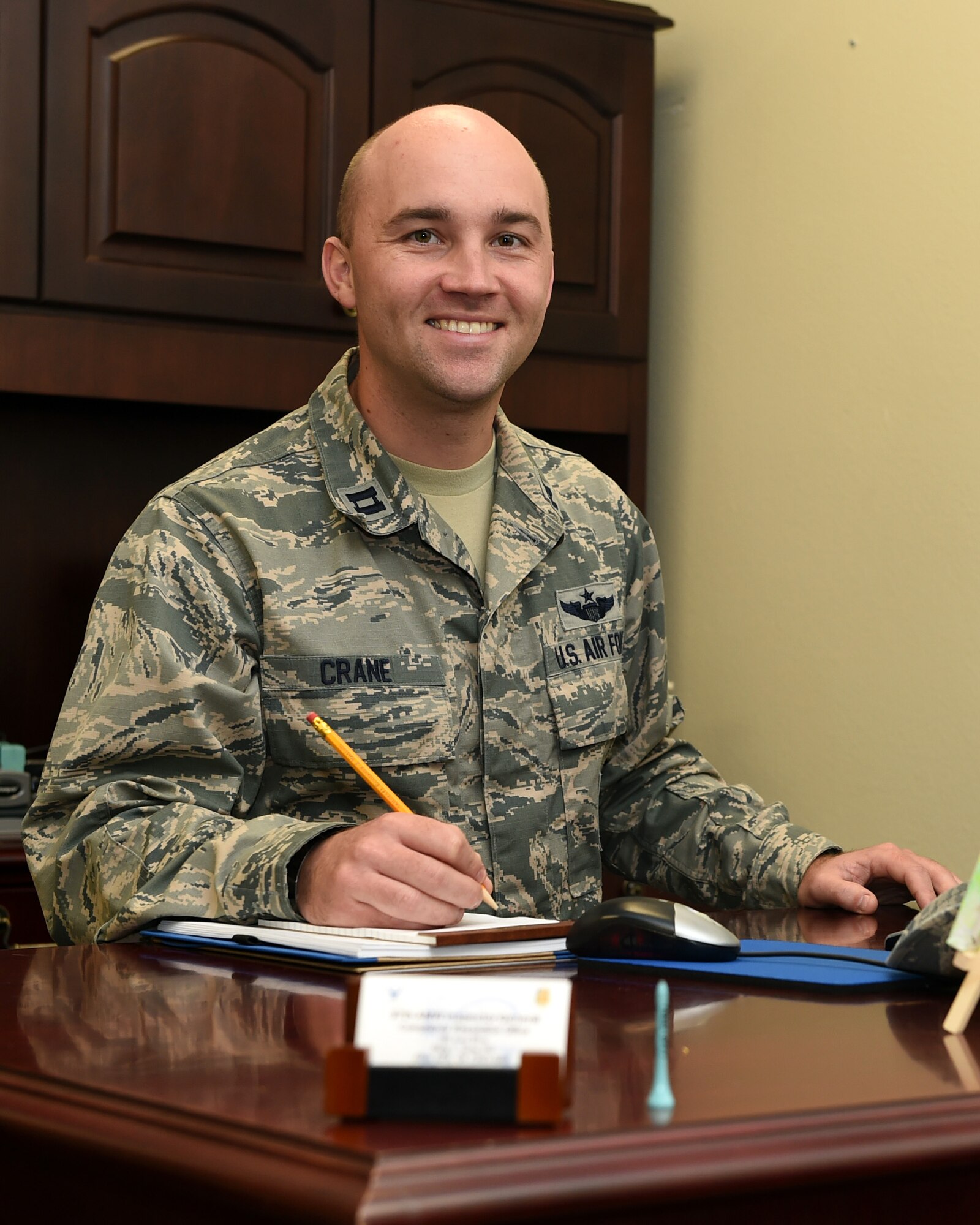 U.S. Air Force Capt. Adam Crane, 97th Air Mobility Wing Deputy Inspector General of complaints and resolution poses at his desk, Sept. 29, 2015. The Inspector General Complaints and Resolution department works to enhance mission effectiveness, morale and productivity through complaint resolution and fraud, waste and abuse prevention. (U.S. Air Force photo by Airman 1st Class Megan E. Acs/Released) 