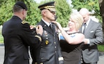 Lt. Gen. Perry L. Wiggins (left), U.S. Army North (Fifth Army) commanding general and senior Army commander of Fort Sam Houston and Camp Bullis, along with Wanda Harris, pin major general rank onto Brian C. Harris during his promotion ceremony at the Quadrangle Sept. 18. 