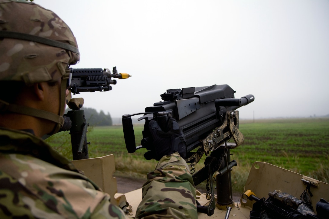 U.S. Army Pfc. Paul Chavez scans a field with his MK-19 automatic grenade launcher during Exercise King Strike in Panevezys, Lithuania, Sept. 22, 2015. Chavez is a paratrooper assigned to Company D, 1st Battalion, 503rd Infantry Regiment, 173rd Airborne Brigade. 