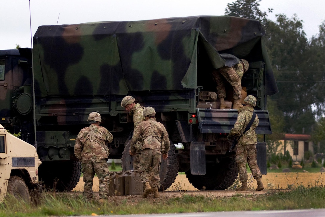 U.S. soldiers re-supply their vehicles during Exercise King Strike in Panevezys, Lithuania, Sept. 22, 2015.