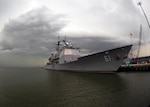 Storm clouds loom on the horizon behind Ticonderoga-class guided-missile cruiser USS Monterey (CG 61) at Naval Station Norfolk, Va. (Photo courtesy of Department of Defense)