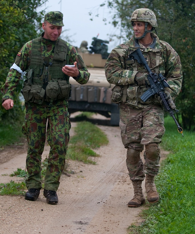1st Sgt. Irmamtas Krikstaponis of Lithuania, left, and U.S. Army Sgt. 1st Class Christopher Nunez talk after a mock enemy attack during Exercise King Strike in Panevezys, Lithuania, Sept. 22, 2015. Nunez is assigned to Company D, 1st Battalion, 503rd Infantry Regiment, 173rd Airborne Brigade. U.S. Army photo by Sgt. Jarred Woods