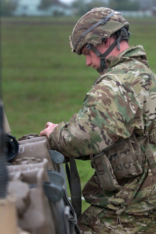 U.S. Army Pvt. Steven Masonheimer secures a fuel canister to a vehicle during Exercise King Strike in Panevezys, Lithuania, Sept. 22, 2015. Masonheimer is an infantryman assigned to Company D, 1st Battalion, 503rd Infantry Regiment, 173rd Airborne Brigade. U.S. Army photo by Sgt. Jarred Woods