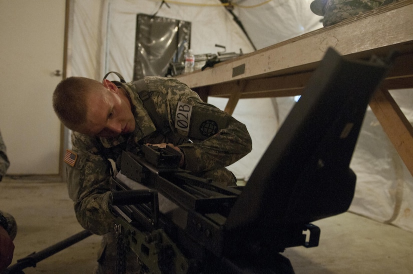 Spc. Mark Whaley, 1138th Engineer Company (Sapper), Missouri National Guard, disassembles a MK 19 grenade launcher during a weapons jumble at Sapper Stakes 2015 in Fort Chaffee, Ark., Aug. 30. Each team member was required to disassemble, reassemble and perform a weapons check on a weapon system. (U.S. Army photo by Staff Sgt. Debralee Best)