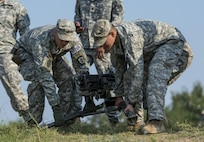 National Guard combat engineers with the 119th Engineer Company (Sapper), from West Virginia, pick up a .50-caliber M2 machine gun during a relay event during Sapper Stakes 2015 competition at Fort Chaffe, Ark., Sept. 1. The competition is designed to build teamwork, enhance combat engineering skills and promote leadership among the units. (U.S. Army photo by Master Sgt. Michel Sauret)