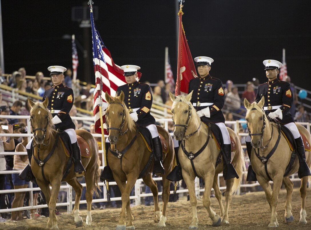 The Marine Corps Mounted Color Guard, from Marine Corps Logistics Base Barstow, Calif, enters the arena for the opening ceremony of the 2015 Barstow Rodeo Stampede, held aboard the base Sept. 25.