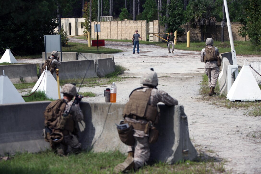 Marines engage a target as they provided security at an entry control point during a security forces training exercise at Marine Corps Base Camp Lejeune, N.C., Sept. 30, 2015. More than 30 Marines with 2nd Low Altitude Air Defense Battalion participated in the week-long training, covering a full spectrum of scenarios they may encounter while deployed. The Marines are all low altitude air defense gunners with the battalion. (U.S. Marine Corps photo by Lance Cpl. Jason Jimenez/Released)