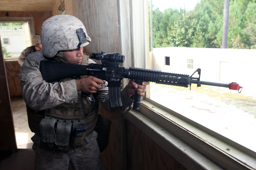 Lance Cpl. Jonathan Velasco engages a target as he provided security during a security forces training exercise at Marine Corps Base Camp Lejeune, N.C., Sept. 30, 2015. More than 30 Marines with 2nd Low Altitude Air Defense Battalion participated in the week-long training, covering a full spectrum of scenarios they may encounter while deployed. Velasco is a low altitude air defense gunner with the battalion. (U.S. Marine Corps photo by Lance Cpl. Jason Jimenez/Released)