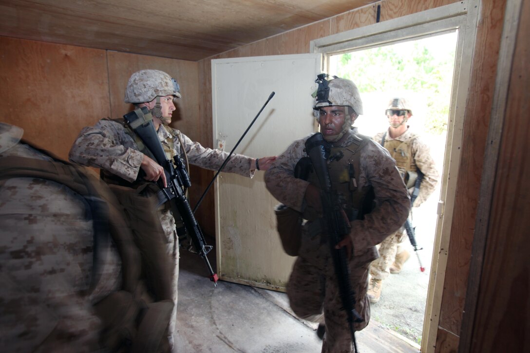 Marines enter a building during a security forces training exercise at Marine Corps Base Camp Lejeune, N.C., Sept. 30, 2015. More than 30 Marines with 2nd Low Altitude Air Defense Battalion participated in the week-long training, covering a full spectrum of scenarios they may encounter while deployed. (U.S. Marine Corps photo by Lance Cpl. Jason Jimenez/Released)
