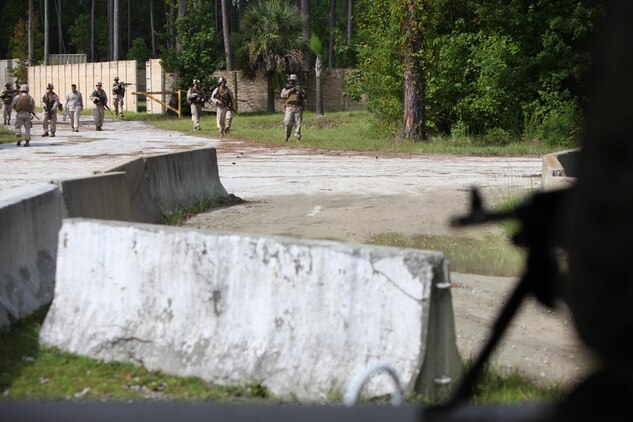 Low altitude air defense gunners search and assess while patrolling during a security forces training exercise at Marine Corps Base Camp Lejeune, N.C., Sept. 30, 2015. More than 30 Marines with 2nd Low Altitude Air Defense Battalion participated in the week-long training, covering a full spectrum of scenarios they may encounter while deployed. (U.S. Marine Corps photo by Lance Cpl. Jason Jimenez/Released)