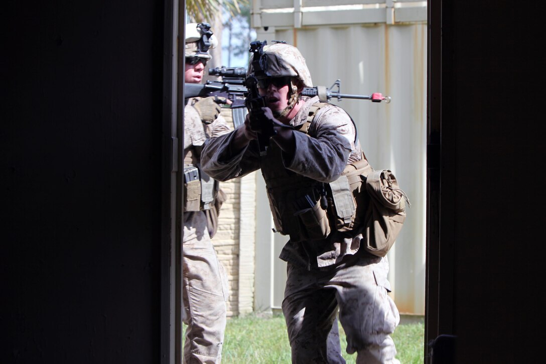 Cpl. Stephen Fernandez, left, follows Cpl. Mark Kilbrige into a dark room to begin clearing a building during a security forces training exercise at Marine Corps Base Camp Lejeune, N.C., Sept. 30, 2015. More than 30 Marines with 2nd Low Altitude Air Defense Battalion participated in the week-long training, covering a full spectrum of scenarios they may encounter while deployed. Kilbrige and Fernandez are both low altitude air defense gunners with the battalion. (U.S. Marine Corps photo by Lance Cpl. Jason Jimenez/Released)