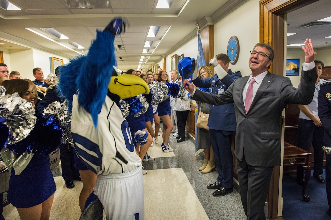 Defense Secretary Ash Carter helps welcome the U.S. Air Force Academy's band, cheerleaders and mascot during a pep rally at the Pentagon, Oct. 2, 2015, on the eve of the football game between the Air Force and Naval academies. DoD photo by Senior Master Sgt. Adrian Cadiz