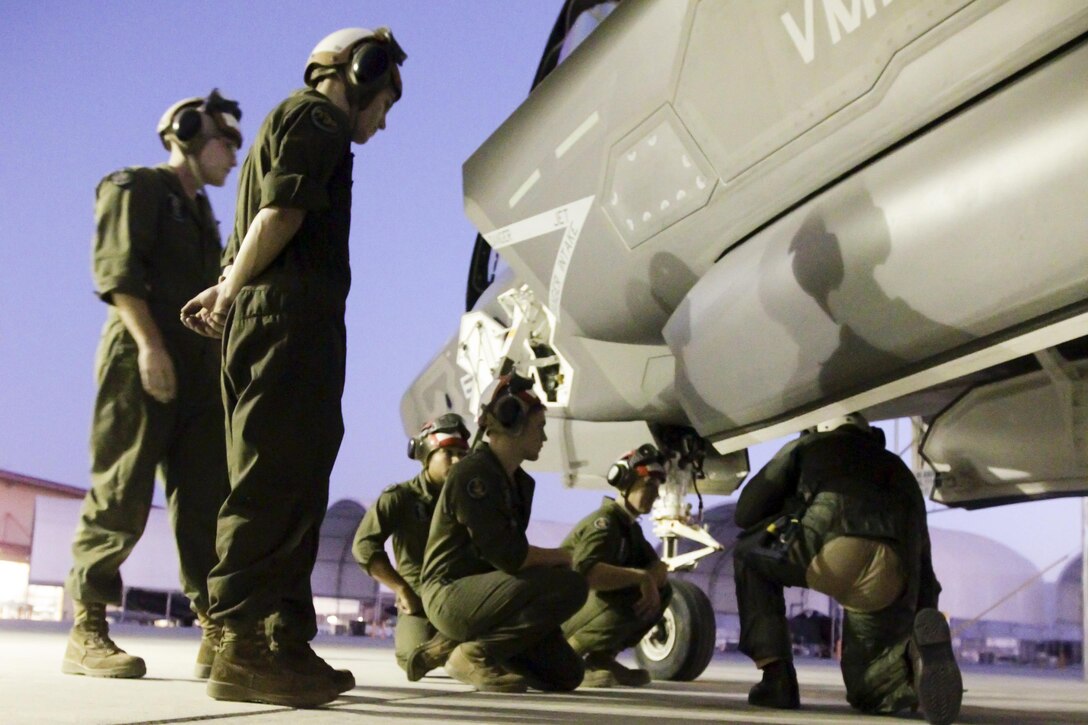 Marines inspect an F-35B Lightning II aircraft during a weapons and tactics instructor course on Marine Corps Air Station Yuma, Ariz., Oct. 1, 2015.  The Marines are with Marine Fighter Attack Squadron 121. U.S. Marine Corps photo by Chief Warrant Officer 3 Jorge A. Dimmer
