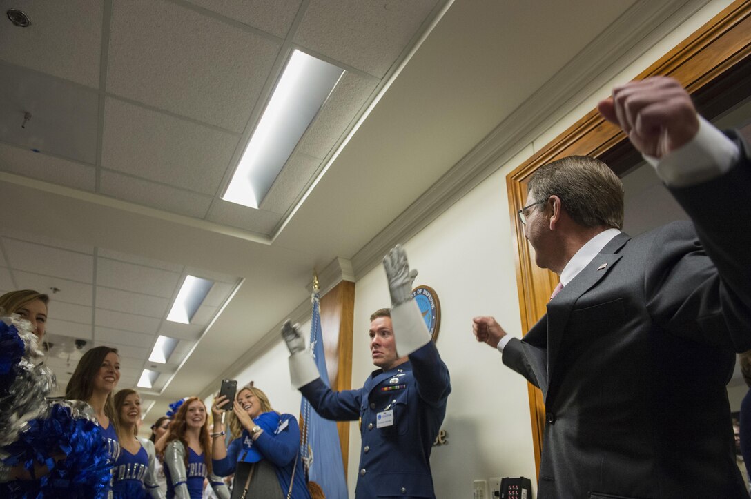 Defense Secretary Ash Carter helps cheer and direct the U.S. Air Force Academy band and cheerleaders during a pep rally at the Pentagon, Oct. 2, 2015. DoD photo by U.S. Air Force Senior Master Sgt. Adrian Cadiz