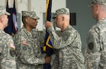 Army Maj. Gen. Timothy McKeithen, the deputy director of the Army National Guard, passes the unit colors to the incoming Operational Support Airlift Agency commander, Army Col. David Doran, during a ceremony Sept. 30, 2015, in Fort Belvoir, Virginia. Doran replaces the outgoing commander, Army Col. James Ring, as OSAA transitions to an activity that reports directly to the commander of the Army Air Operations Group, or AAOG, and realigns itself under the Military District of Washington as part of Army reorganization.
