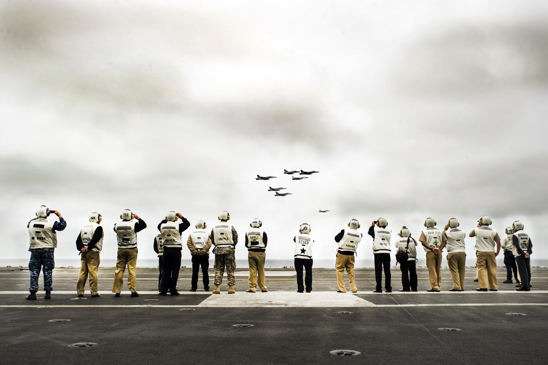 Guests photograph U.S. and Peruvian navy jets flying in formation by the aircraft carrier USS George Washington in the Pacific Ocean, Sept. 30, 2015. The George Washington is deployed around South America as part of Southern Seas 2015, an operation aimed at enhancing interoperability, increasing regional stability and building and maintaining relationships with countries in the region. U.S. Navy photo by Petty Officer 3rd Class Bryan Mai
