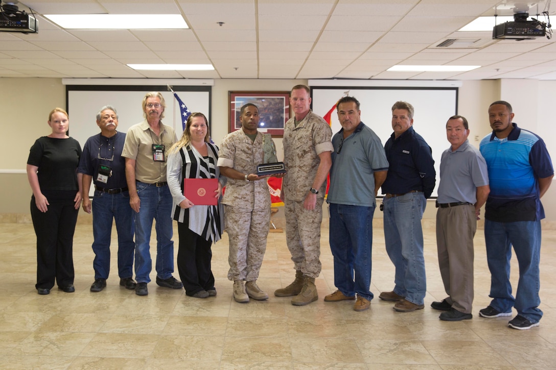 Brig.Gen. Edward D. Banta, commanding general Marine Corps Installation West-MCB Camp Pendleton, presents the 2014 Marine Corps Warrior Preservation Award to Col Sekou Karega, commanding officer of MCLB Barstow, and the base safety staff, Sept 29. The safety staff at MCLB Barstow is being recognized for their significant contributions and accomplishments in the area of safety, mishap prevention, and force preservation during fiscal year 2014.
