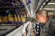 An Airman-in-Training restocks the shredded cheese section at the Defense Commissary Agency cooler shelves on Sheppard Air Force Base, Texas, Sept. 27, 2015.  More than 150 Airmen and volunteers helped rescue more than $200,000 in perishable grocery items from a lighting strike that shut down the commissary power. (U.S. Air Force photo/Tech. Sgt. Mike Meares)
