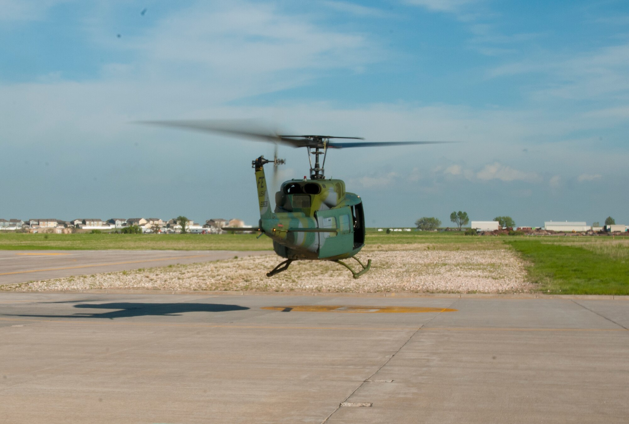 A 37th Helicopter Squadron UH-1N “Huey” Bell Helicopter hovers over the 37th HS helicopter movement area on F.E. Warren Air Force Base, Wyo., Jun 12, 2015. Helicopter operations run 24/7 on base and throughout the 90th Missile Wing missile complex. (U.S. Air Force photo by Senior Airman Jason Wiese)