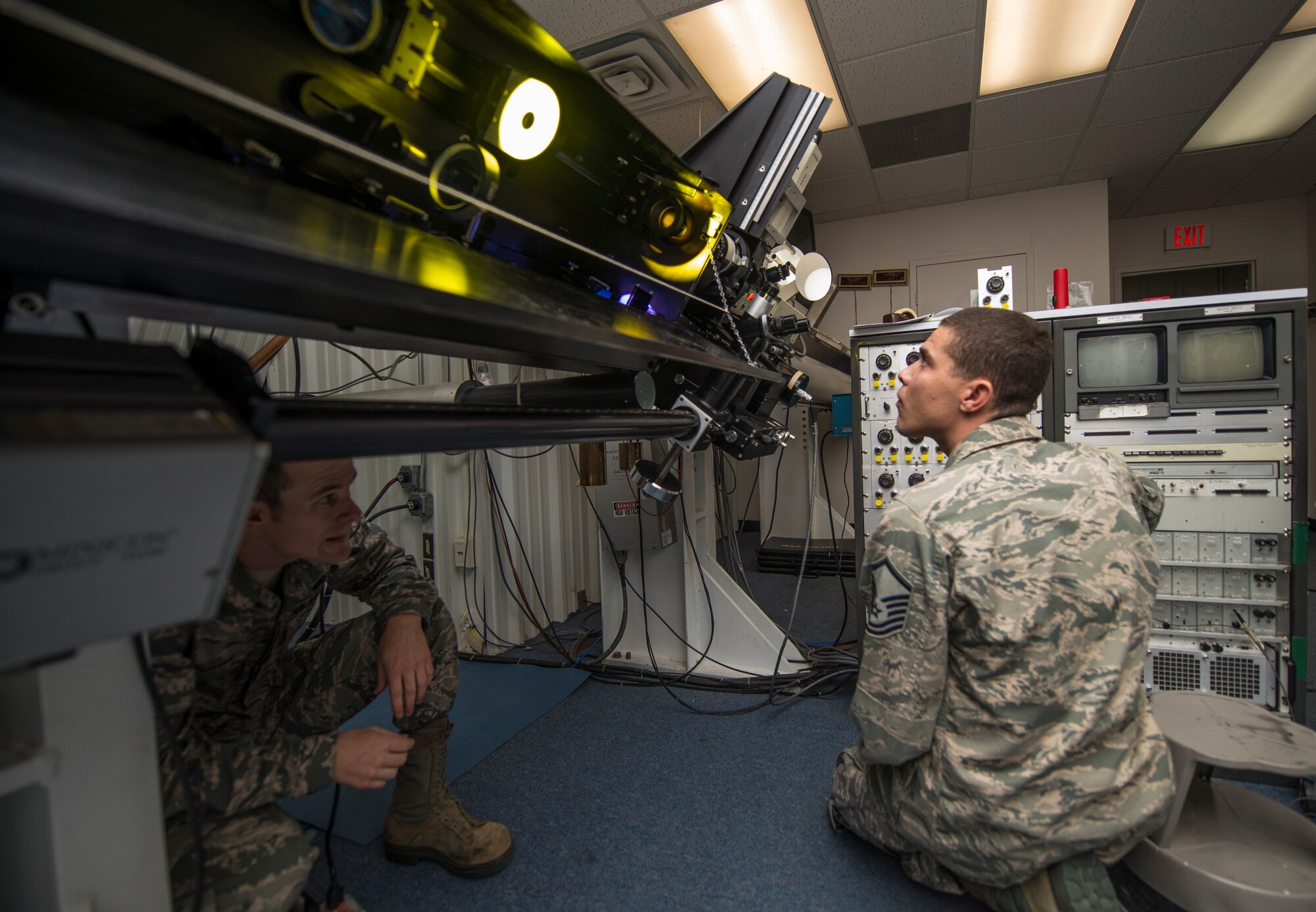 Master Sgt. Kenneth Moncrief and Senior Airman Samuel Davis test the solar telescope after conducting repairs at the Holloman Solar Observatory on Sept. 24. Moncrief and Davis are the two depot-level maintenance technicians from the 2nd Weather Squadron, Det. 4 who service and maintain three solar telescopes around the world, the other two being in Learmonth, Australia and San Vito, Italy. (U.S. Air Force photo by Senior Airman Aaron Montoya)