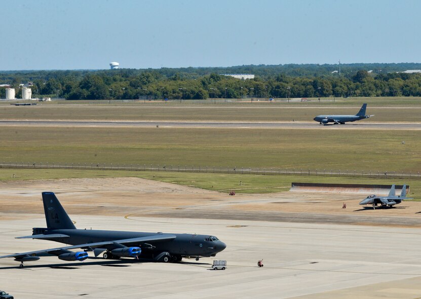 A B-52 Stratofortress, KC-135 Stratotanker and F-15E Strike Eagle share the flightline at Barksdale Air Force Base, La., Oct. 2, 2015. Hundreds of aircrew and more than 65 aircraft from Seymour Johnson AFB, N.C., relocated to avoid potential damage from high winds associated with Hurricane Joaquin along the East Coast. (U.S. Air Force photo/Airman 1st Class Mozer O. Da Cunha)