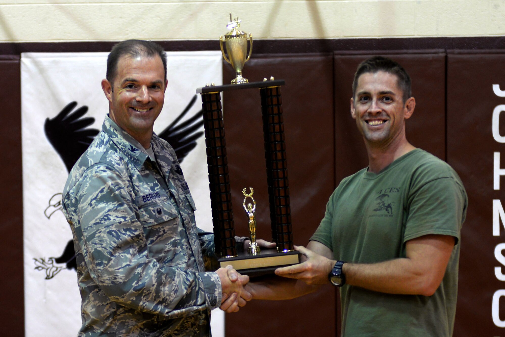 Maj. James Melvin, 4th Civil Engineering Squadron operations flight commander, accepts the first place trophy for large squadrons from Col. Andrew Bernard, 4th Fighter Wing vice commander at the conclusion of Comprehensive Airman Fitness Day, Sept. 30, 2015, at Seymour Johnson Air Force Base, North Carolina. The 4th CES totaled 94 points during the competition, narrowly edging out the 4th Equipment Maintenance Squadron, who had 90. (U.S. Air Force photo/Airman 1st Class Ashley Williamson)