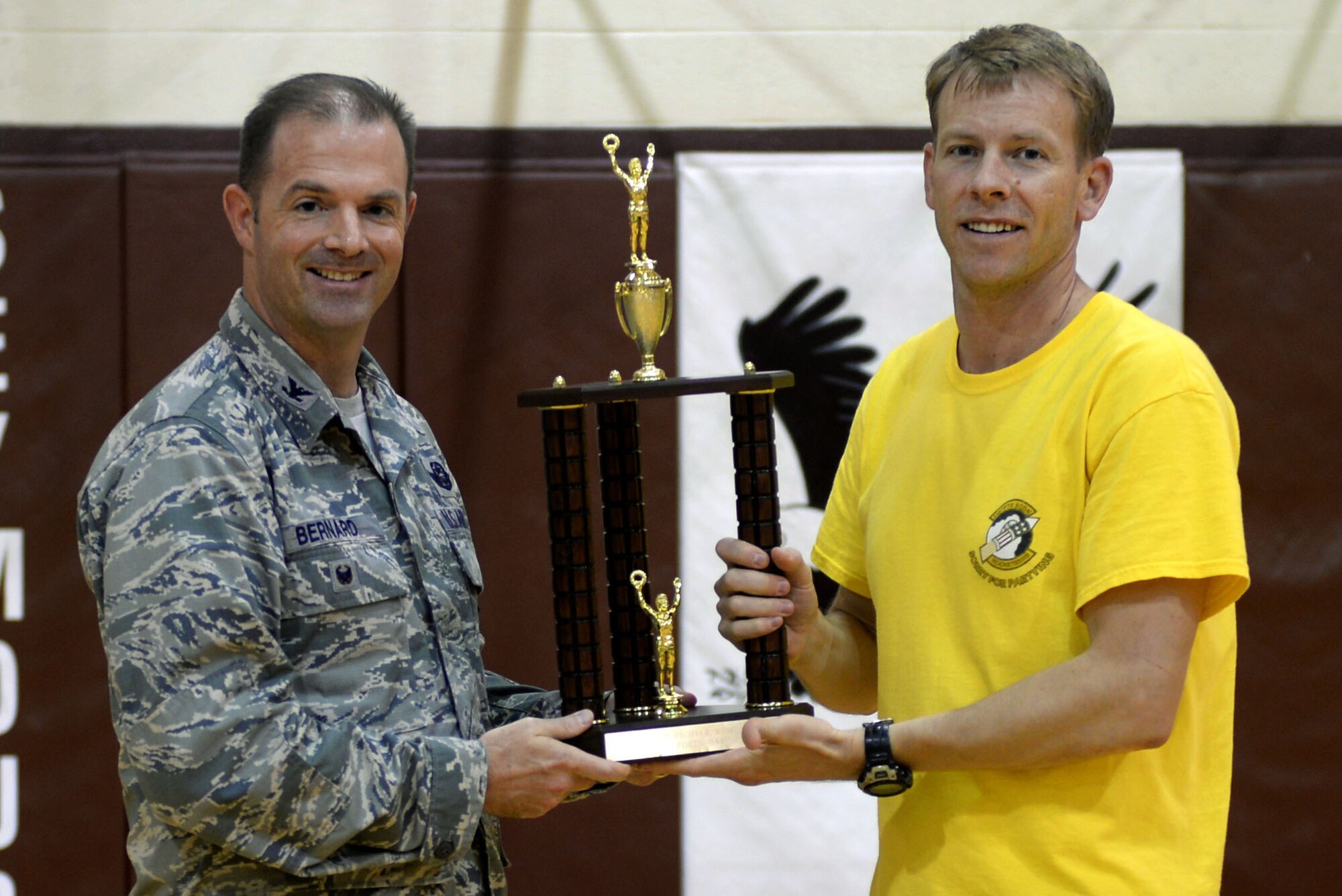 Lt. Col.  Paul Jeffords, 336th Fighter Squadron director of operations, receives the first place trophy for small squadrons from Col. Andrew Bernard, 4th Fighter Wing vice commander, Sept. 30, 2015, at Seymour Johnson Air Force Base, North Carolina. After taking part in all the events for Comprehensive Airman Fitness Day, the 335th Fighter Squadron won second place, and the 4th Force Support Squadron won third place. (U.S. Air Force photo/Airman 1st Class Ashley Williamson)