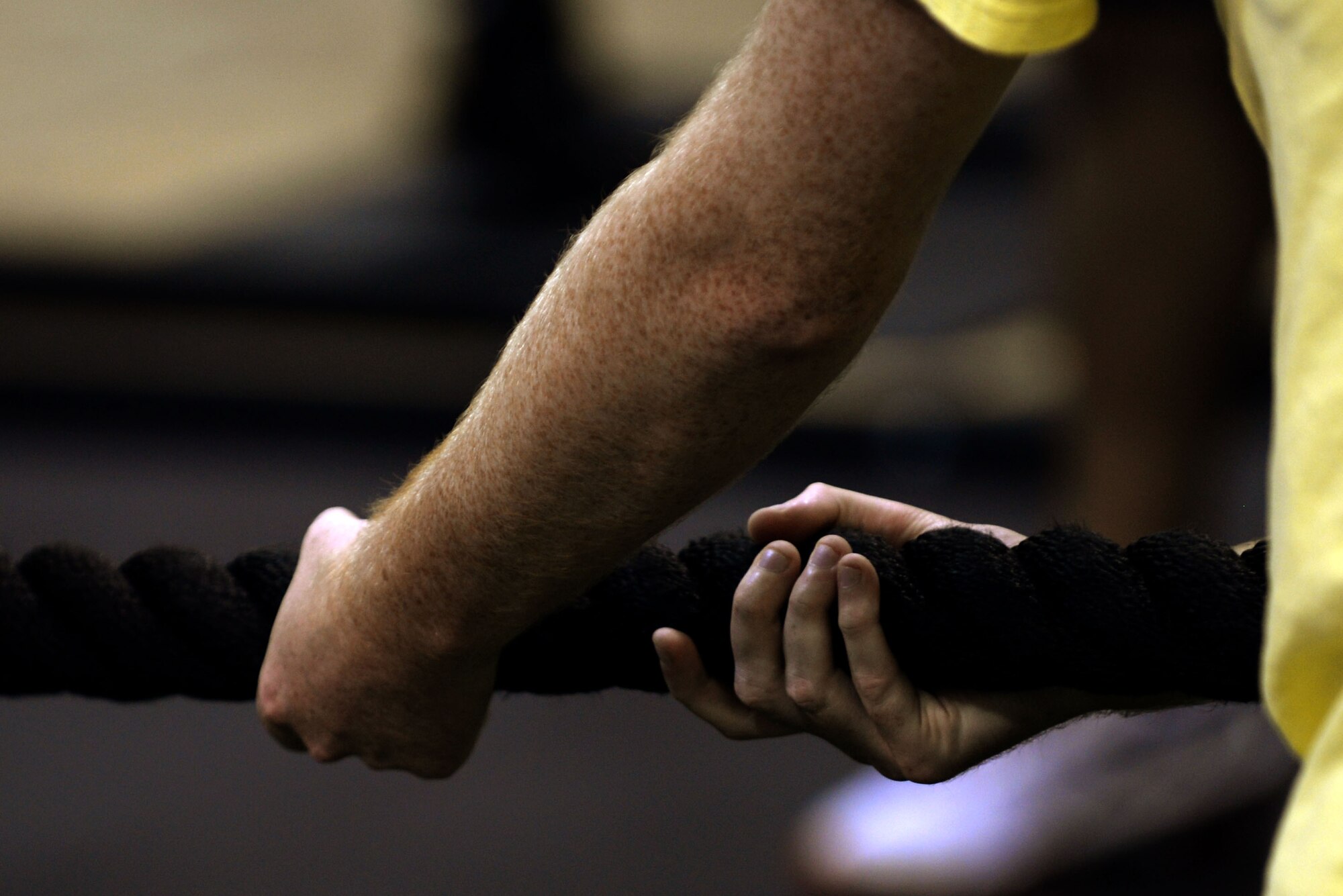 An Airman participates in a game of tug-of-war during Comprehensive Airman Fitness Day, Sept. 30, 2015, at Seymour Johnson Air Force Base, North Carolina. Teams of four or five battled to see who could pull the other over the middle of the playing field in order to be declared the winner. (U.S. Air Force photo/Airman 1st Class Ashley Williamson)
