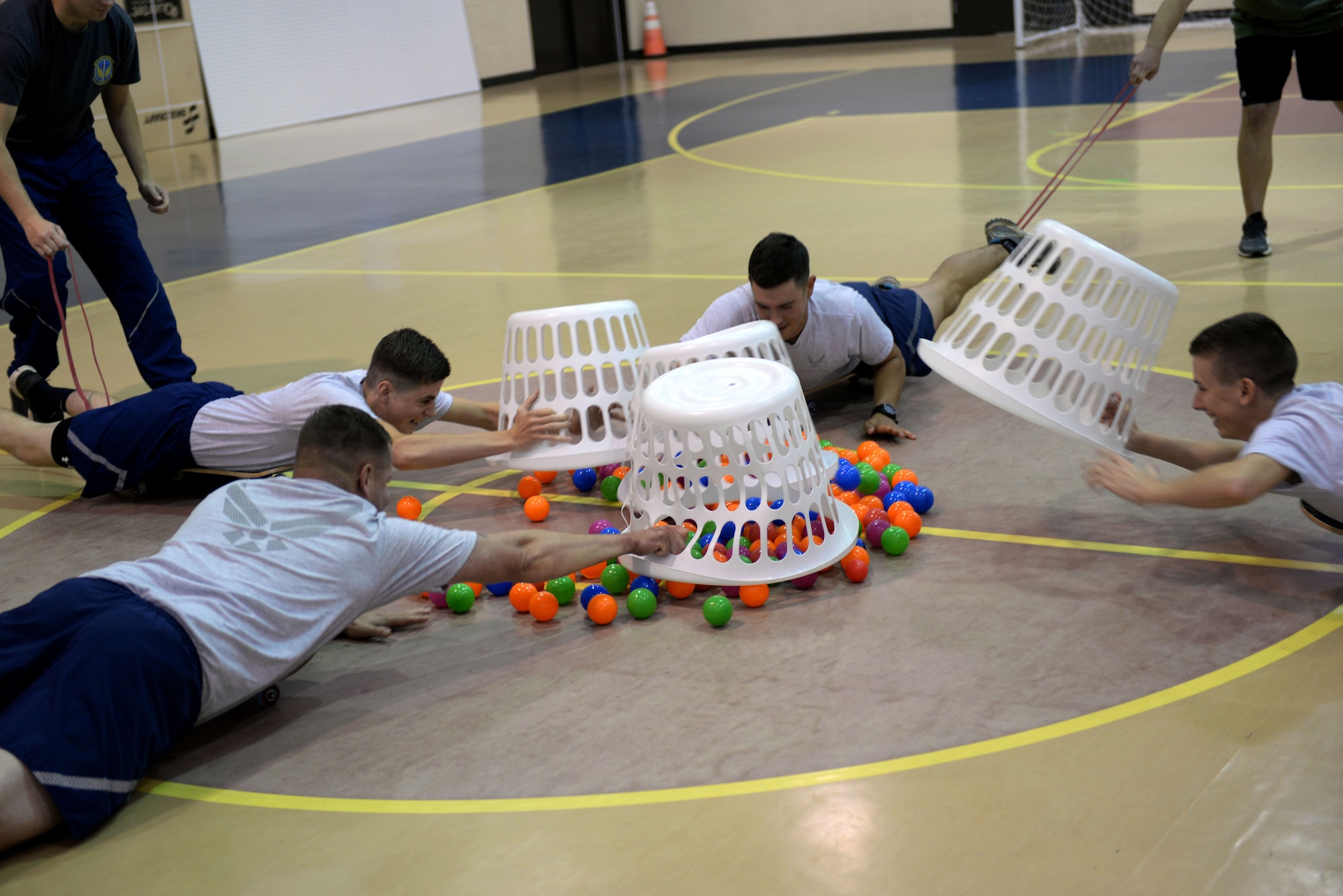 Team Seymour Airmen participate in a game of Human Hungry Hippos during Comprehensive Airman Fitness Day, Sept. 30, 2015, at Seymour Johnson Air Force Base, North Carolina. The event pitted teams of two against each other to see who could collect the most balls from the center of the play area using baskets and skateboards. (U.S. Air Force photo/Airman 1st Class Ashley Williamson)