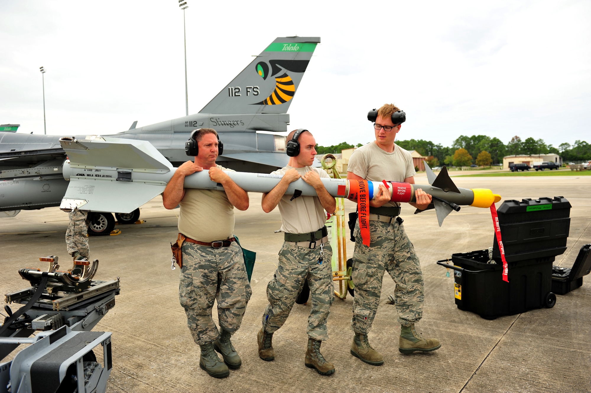 Weapons loaders from the 180th Fighter Wing, Ohio Air National Guard, transport an AIM-9 to be loaded on an F-16 Fighting Falcon Sept. 15, at Tyndall Air Force Base, Fla. About 120 Airmen from the 180th FW traveled to Tyndall to participate in the Combat Archer exercise, a 53rd Wing weapons system evaluation program designed to test the effectiveness of Airmen and air-to-air weapon system capability of combat aircraft.  (U.S. Air Force photo/Senior Master Sgt. Beth Holliker)