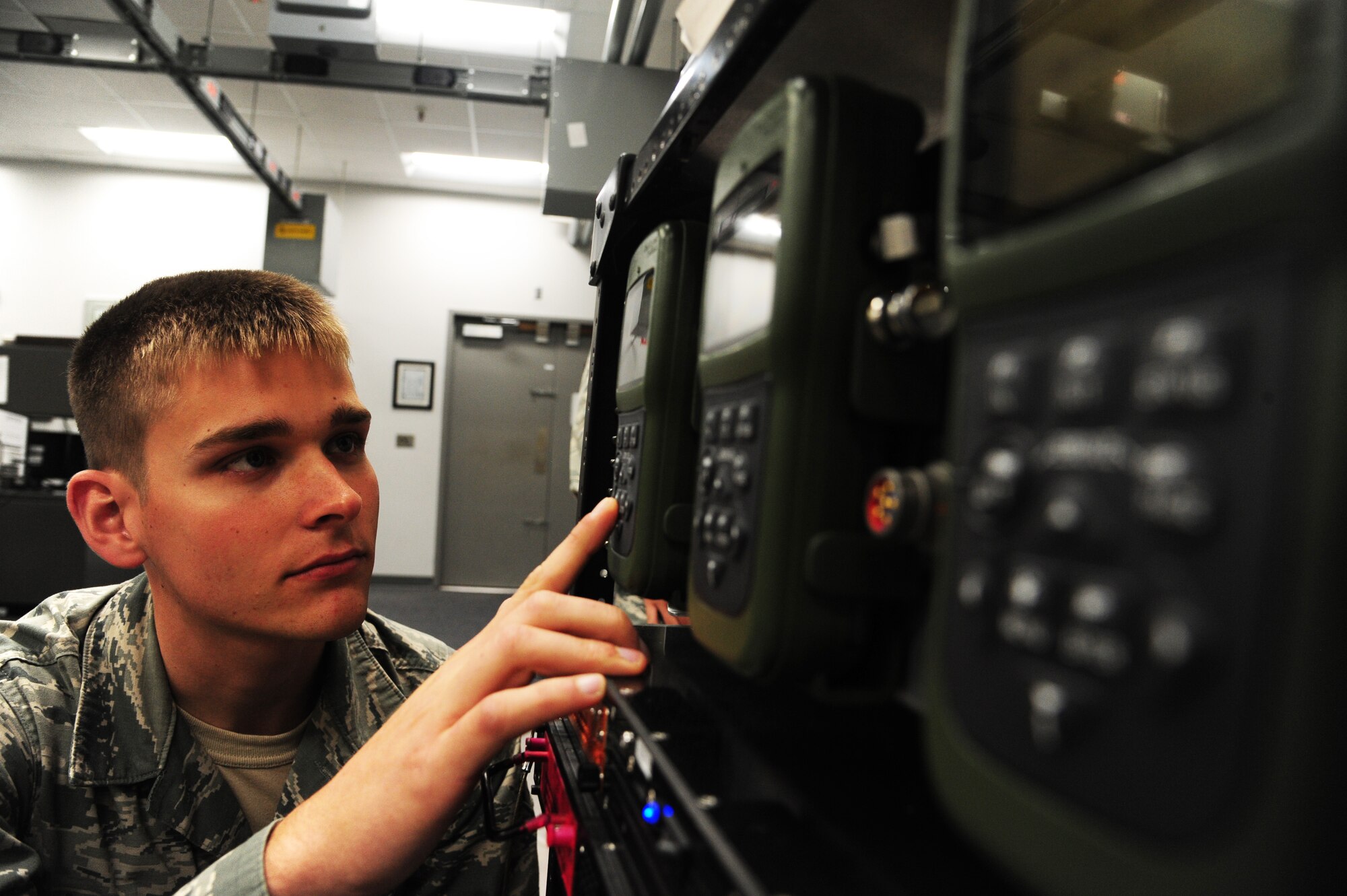 Airman 1st Class Michael Bentley, 509th Maintenance Squadron avionics backup technician, inspects an adaptable communication suite GPS receiver at Whiteman Air Force Base, Mo., Oct. 1, 2015. The GPS receiver, a new component, is used for the B-2 Spirit communication system. (U.S Air Force photos by Senior Airman Keenan Berry/Released)